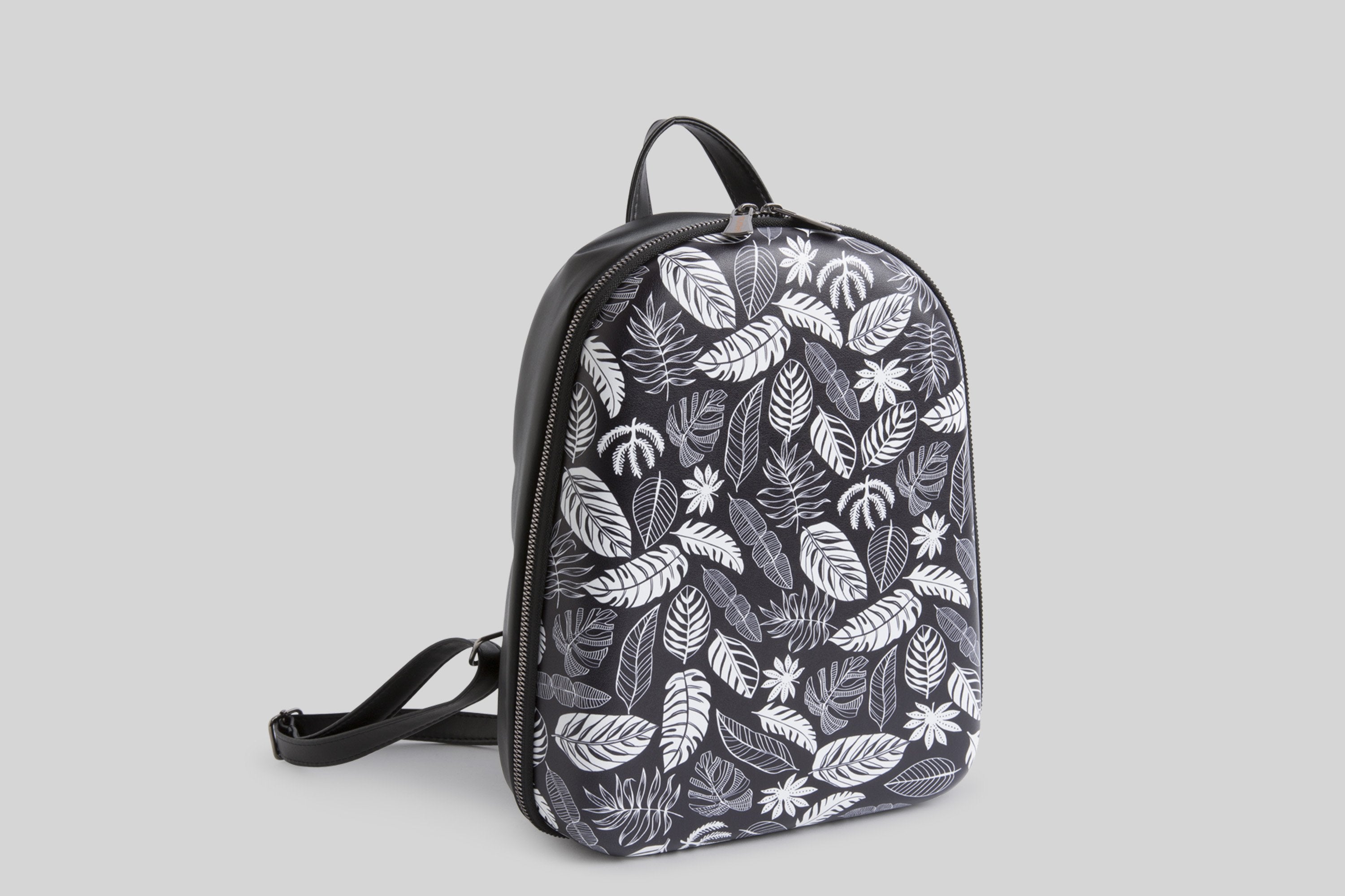 woman-black-and-white-leaves-backpack